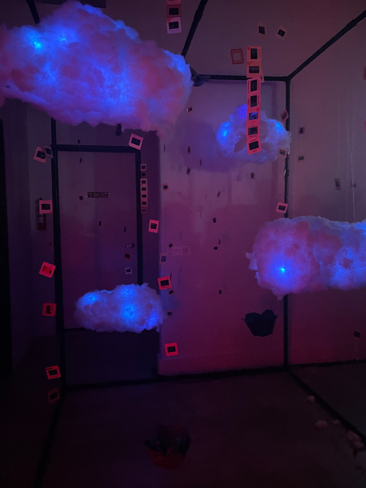 Installation lit in blue and red with suspended film slides