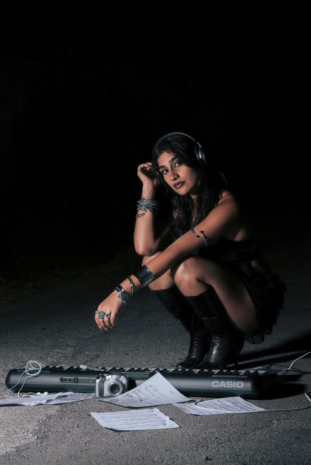 Minor Key editorial, model crouched over a keyboard wearing headphones