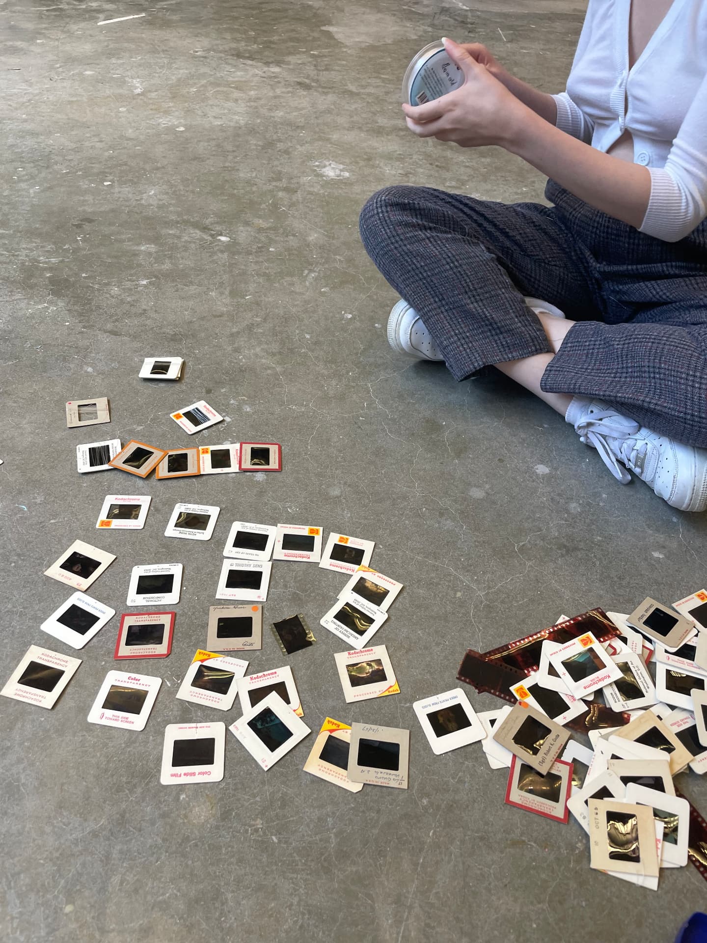 Sorting vintage film slides on the studio floor