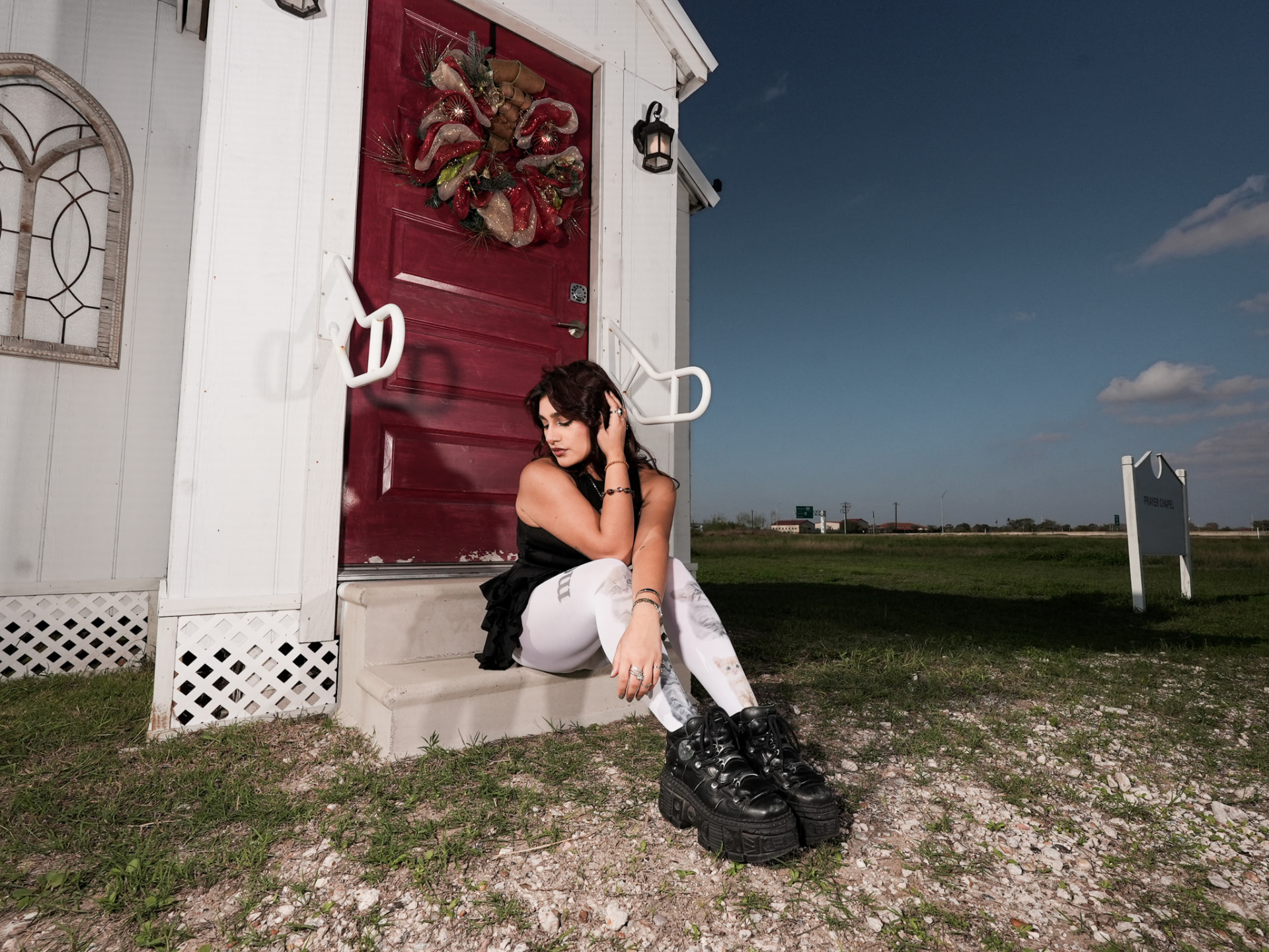 Pikupajku campaign, seated on the chapel steps in printed tights