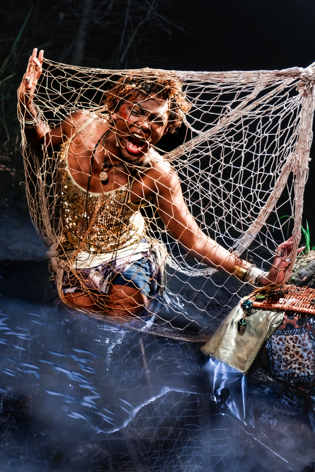 Freeze promo, model holding a fishing net above the creek water