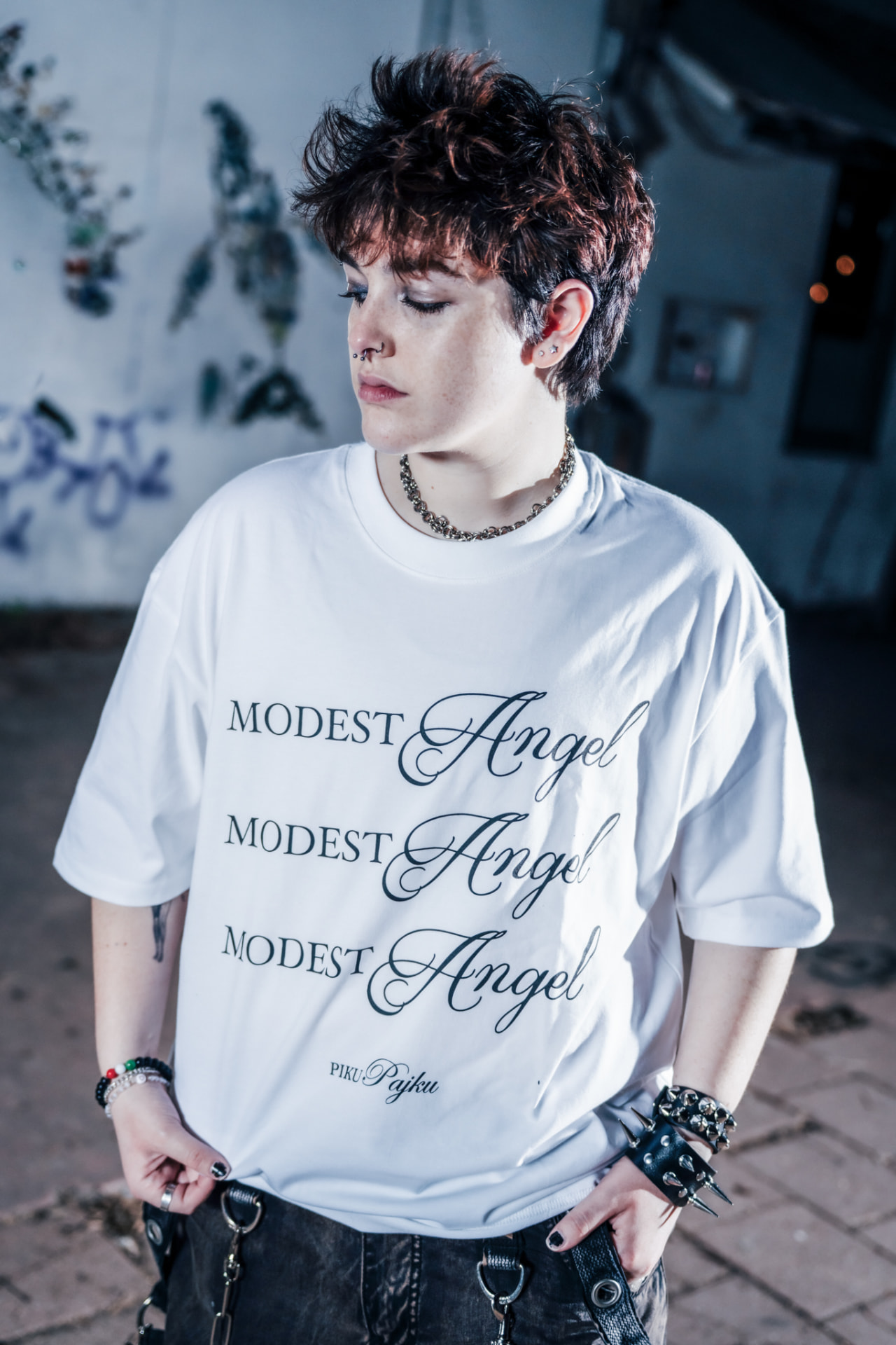 Modest Angel campaign, model in the printed tee against a graffiti wall